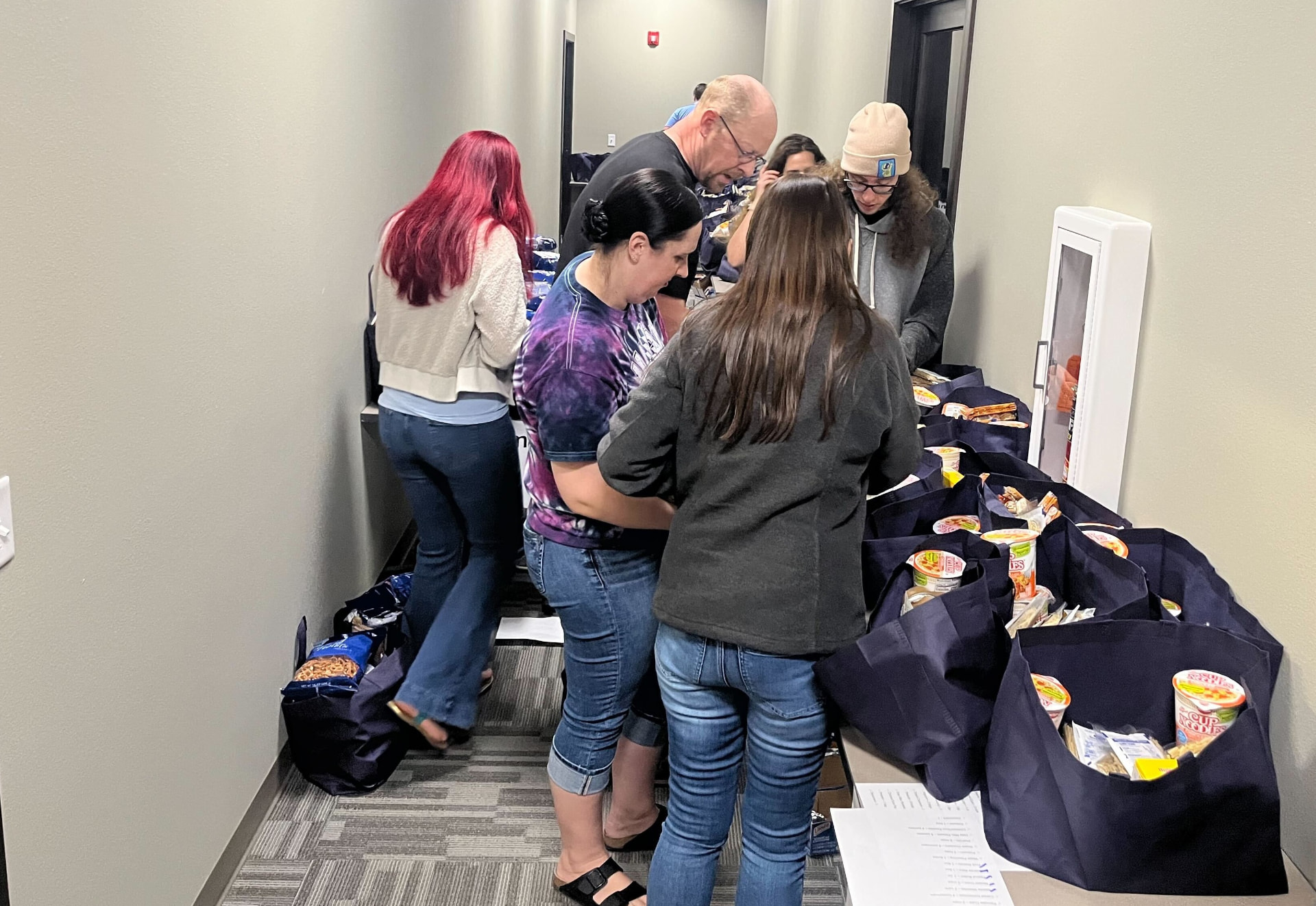 Daycos team members volunteering and packing community support bags